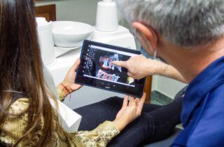 dentist and patient looking at dental X-rays | Maitland Ave Smile Co.