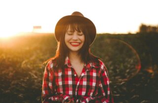 woman in a plaid shirt and smiling | dentistaltamonte.com